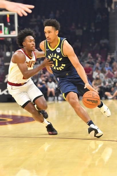 Darius Garland of the Cleveland Cavaliers tries to guard Malcolm Brogdon of the Indiana Pacers during the first quarter at Rocket Mortgage Fieldhouse...