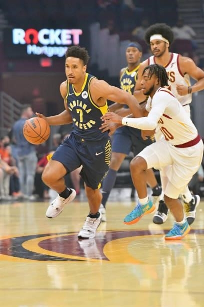 Malcolm Brogdon of the Indiana Pacers brings the ball up court around Darius Garland of the Cleveland Cavaliers during the first quarter at Rocket...