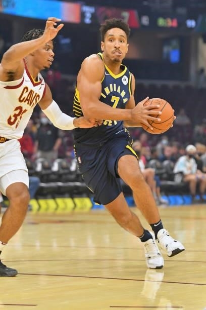 Isaac Okoro of the Cleveland Cavaliers tries to guard Malcolm Brogdon of the Indiana Pacers during the first quarter at Rocket Mortgage Fieldhouse on...