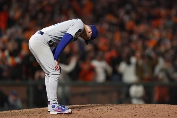 Walker Buehler of the Los Angeles Dodgers reacts after allowing a solo home run to Kris Bryant of the San Francisco Giants during the seventh inning...