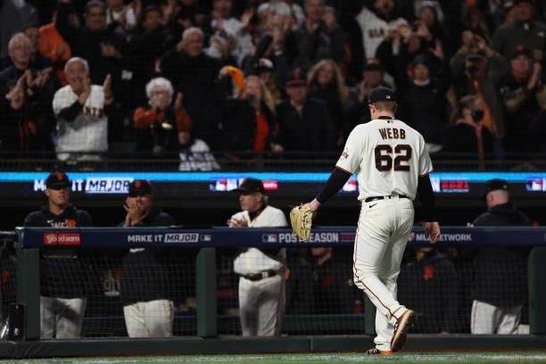 Logan Webb of the San Francisco Giants walks to the dugout after being taken out of the game against the Los Angeles Dodgers during the eighth inning...
