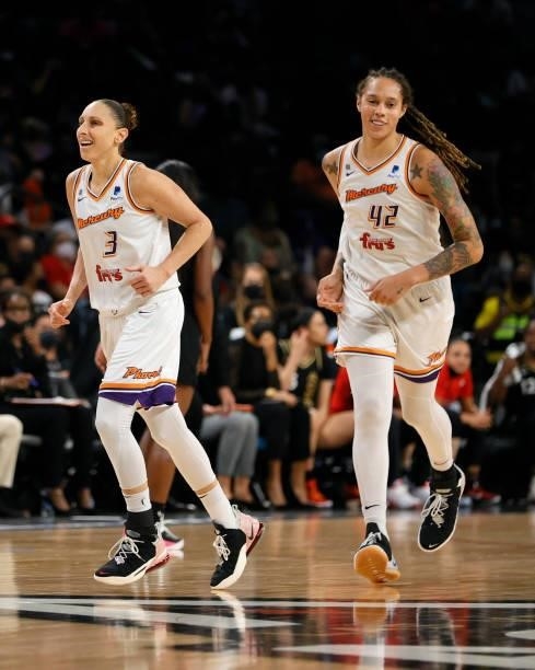 Diana Taurasi and Brittney Griner of the Phoenix Mercury react as they run back on defense after Taurasi hit a 3-pointer against the Las Vegas Aces...