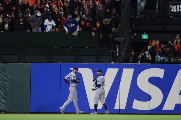 Cody Bellinger and Mookie Betts of the Los Angeles Dodgers react after Brandon Crawford of the San Francisco Giants hit a solo home run off Alex...