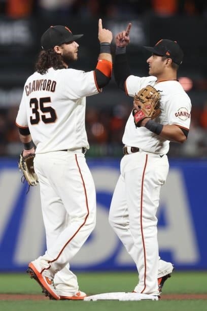 Brandon Crawford and Donovan Solano of the San Francisco Giants celebrate after defeating the Los Angeles Dodgers 4-0 in Game 1 of the National...