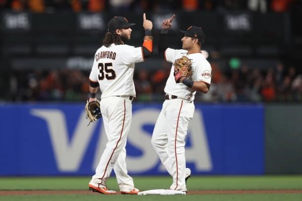 Brandon Crawford and Donovan Solano of the San Francisco Giants celebrate after defeating the Los Angeles Dodgers 4-0 in Game 1 of the National...