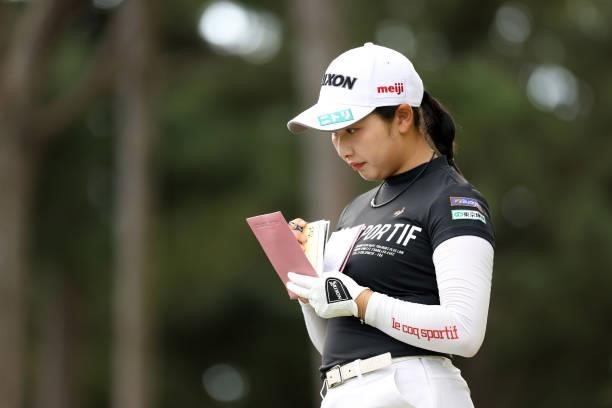 Sakura Koiwai of Japan checks her yardage book on the 6th tee during the second round of the Stanley Ladies at Tomei Country Club on October 9, 2021...
