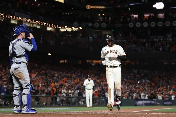 Kris Bryant of the San Francisco Giants crosses home plate after hitting a solo home run off Walker Buehler of the Los Angeles Dodgers during the...