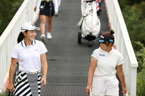 Miyuu Yamashita and amateur Miyu Sato talk on their way to the 6th green during the second round of the Stanley Ladies at Tomei Country Club on...