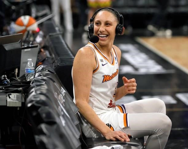 Diana Taurasi of the Phoenix Mercury reacts to cheering fans as she waits for a television interview after the team's 87-84 victory over the Las...