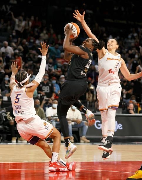 Chelsea Gray of the Las Vegas Aces drives to the basket against Shey Peddy and Diana Taurasi of the Phoenix Mercury during Game Five of the 2021 WNBA...