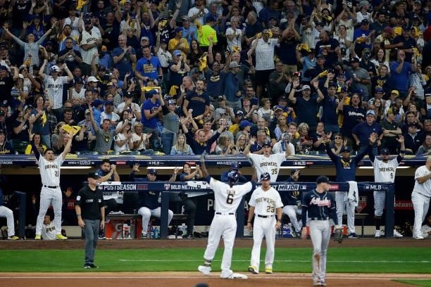 Brewer fans react after Lorenzo Cain reaches first base during Game One of the National League division series at American Family Field on October...