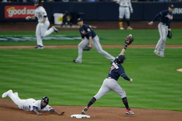 Lorenzo Cain of the Milwaukee Brewers is forced out while sliding into second base as Dansby Swanson of the Atlanta Braves takes the throw during...