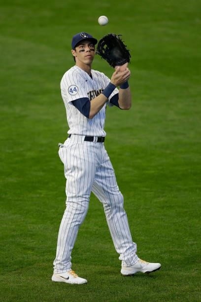 Christian Yelich of the Milwaukee Brewers warms up between innings against the Atlanta Braves in the sixth inning during Game One of the National...