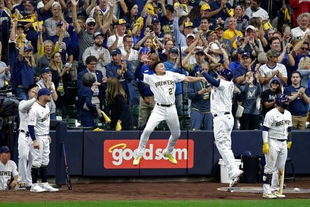 Willy Adames of the Milwaukee Brewers congratulates Rowdy Tellez of the Milwaukee Brewers after a two run homer in the seventh inning against the...