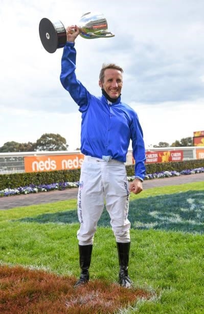 Damien Oliver poses with the trophy after riding Anamoe to win in Race 8, the Neds Caulfield Guineas, winning during Melbourne Racing at Caulfield...