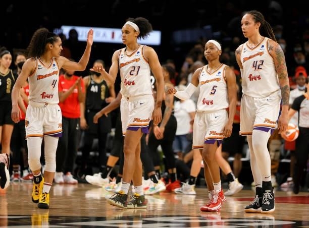 Skylar Diggins-Smith, Brianna Turner, Shey Peddy and Brittney Griner of the Phoenix Mercury walk on the court after Peddy hit two out of three free...