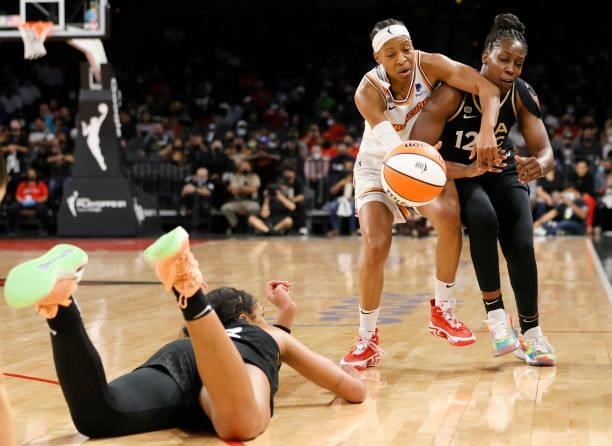 Ja Wilson of the Las Vegas Aces dives on the floor as she tries to pass the ball to Chelsea Gray against Shey Peddy of the Phoenix Mercury during...