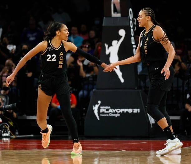 Ja Wilson and Liz Cambage of the Las Vegas Aces celebrate after the team scored against the Phoenix Mercury during Game Five of the 2021 WNBA...