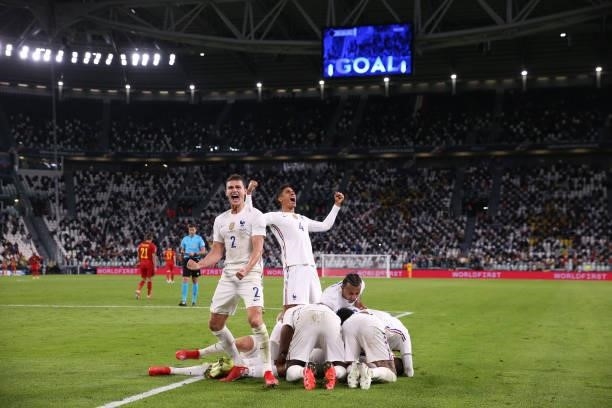 Theo Hernandez of France celebrates with team mates after scoring to give the side a 3-2 lead during the UEFA Nations League 2021 Semi-final match...