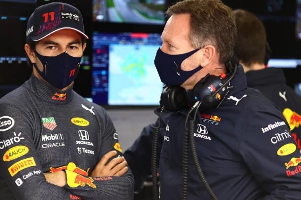 Sergio Perez of Mexico and Red Bull Racing and Red Bull Racing Team Principal Christian Horner talk in the garage during final practice ahead of the...