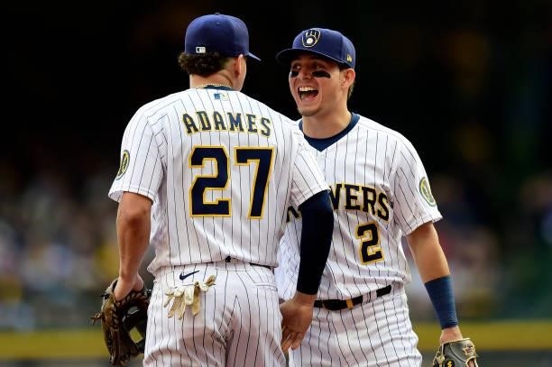 Willy Adames and Luis Urias of the Milwaukee Brewers celebrate a catch in the first inning during game 2 of the National League Division Series...