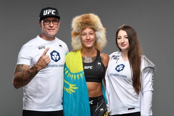Mariya Agapova of Kazakhstan poses for a portrait backstage with her team during the UFC Fight Night event at UFC APEX on October 09, 2021 in Las...