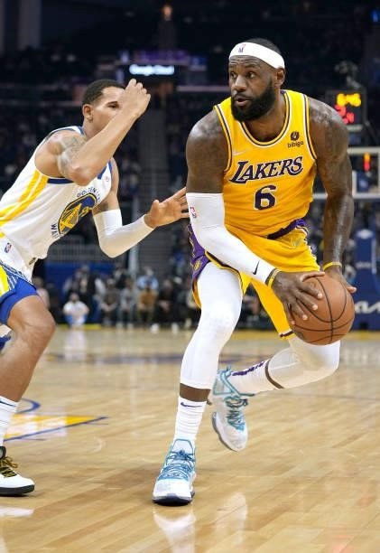 LeBron James of the Los Angeles Lakers looks to shoot over Juan Toscano-Anderson of the Golden State Warriors at Chase Center on October 08, 2021 in...