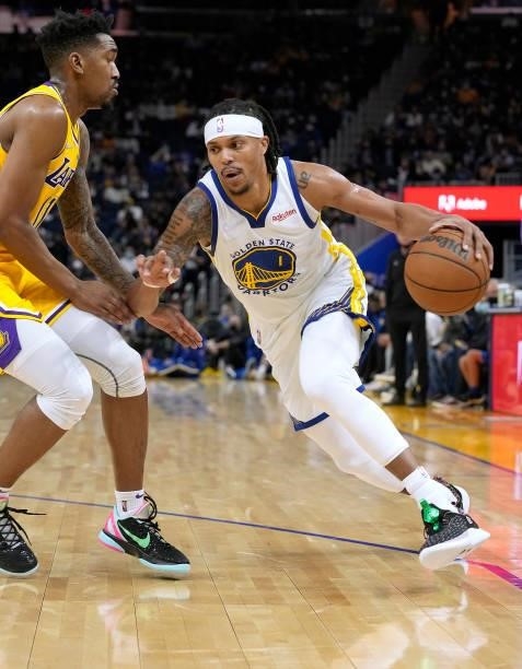 Damion Lee of the Golden State Warriors drives towards the basket on Malik Monk of the Los Angeles Lakers at Chase Center on October 08, 2021 in San...