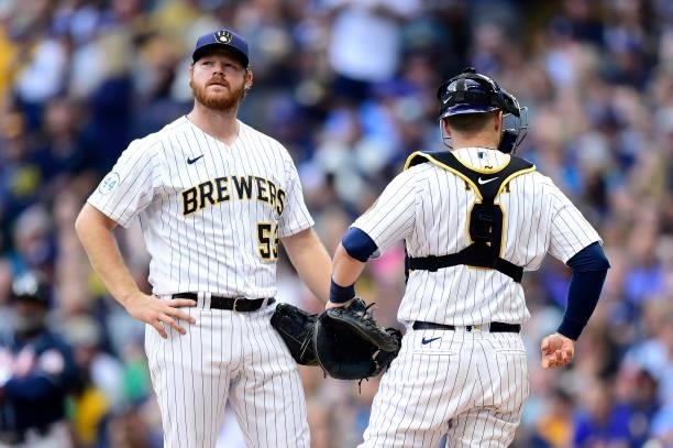 Brandon Woodruff of the Milwaukee Brewers speaks with Manny Pina of the Milwaukee Brewers on the mound in the third inning during game 2 of the...