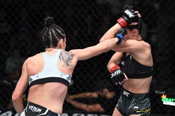 Marina Rodriguez of Brazil punches Marina Rodriguez of Brazil in their women's strawweight bout during the UFC Fight Night event at UFC APEX on...