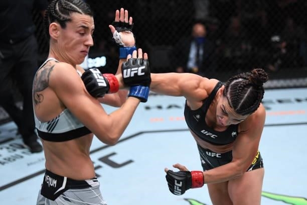 Mackenzie Dern punches Marina Rodriguez of Brazil in their women's strawweight bout during the UFC Fight Night event at UFC APEX on October 09, 2021...