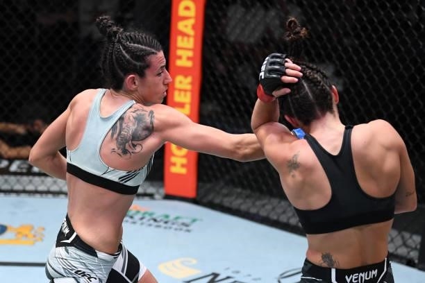 Marina Rodriguez of Brazil punches Mackenzie Dern in their women's strawweight bout during the UFC Fight Night event at UFC APEX on October 09, 2021...