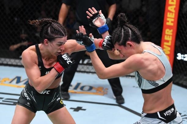 Mackenzie Dern punches Marina Rodriguez of Brazil in their women's strawweight bout during the UFC Fight Night event at UFC APEX on October 09, 2021...