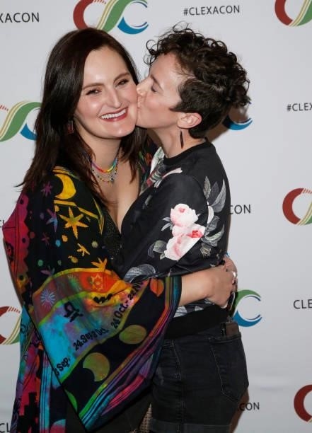 Actress Mary Chieffo and actor/writer Madi Goff kiss during the ClexaCon 2021 convention at the Tropicana Las Vegas on October 09, 2021 in Las Vegas,...