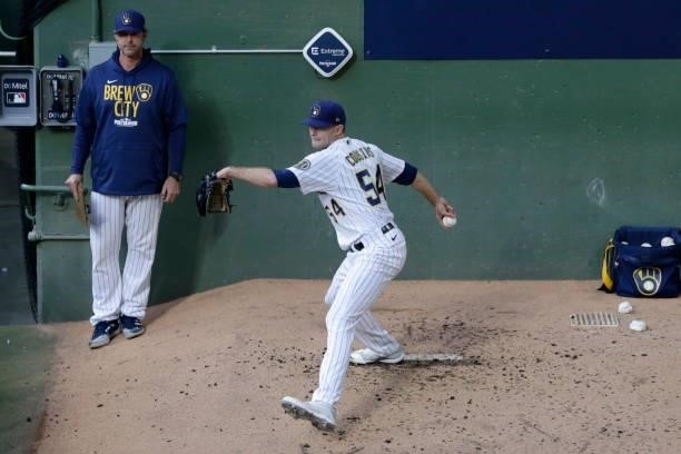 Jake Cousins of the Milwaukee Brewers warms up in the bullpen in the fifth inning during game 2 of the National League Division Series against the...