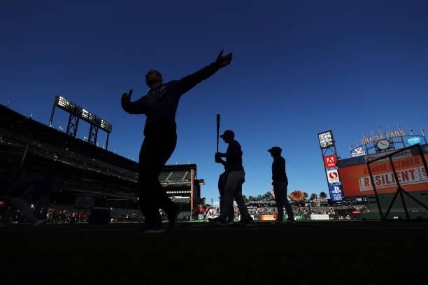 The Los Angeles Dodgers warm up before Game 2 of the National League Division Series against the San Francisco Giants at Oracle Park on October 09,...