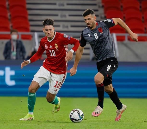 Dominik Szoboszlai of Hungary competes for the ball with Klaus Gjasula of Albania during the FIFA World Cup 2022 Qatar Qualifier match between...