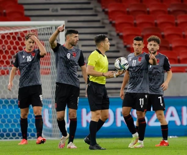 Referee Carlos del Cerro Grande holds the ball in front of Klaus Gjasula of Albania , Myrto Uzuni of Albania and Keidi Bare of Albania during the...