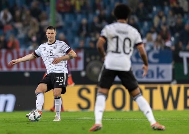 Niklas Suele of Germany passes the ball during the 2022 FIFA World Cup Qualifier match between Germany and Romania at Imtech Arena on October 08,...