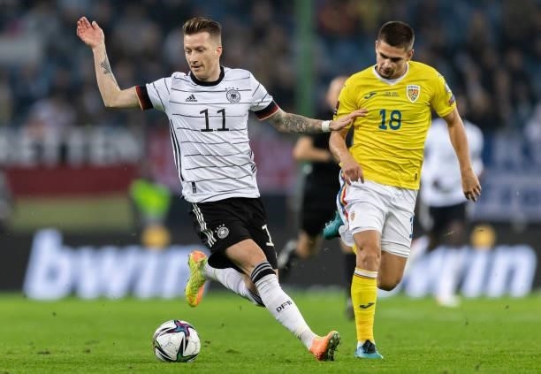 Marco Reus of Germany is challenged by Razvan Marin of Romania during the 2022 FIFA World Cup Qualifier match between Germany and Romania at Imtech...