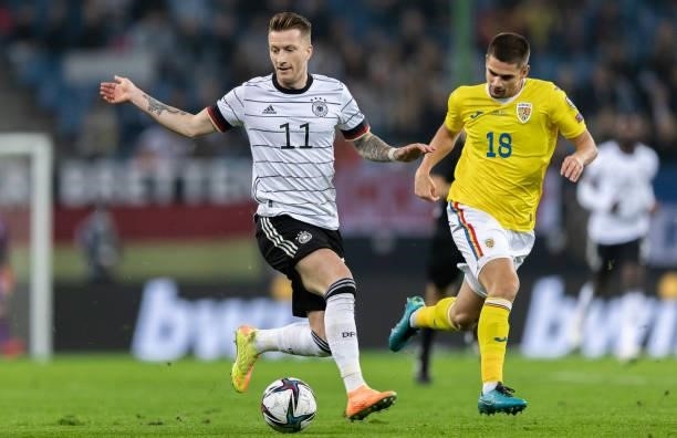 Marco Reus of Germany is challenged by Razvan Marin of Romania during the 2022 FIFA World Cup Qualifier match between Germany and Romania at Imtech...