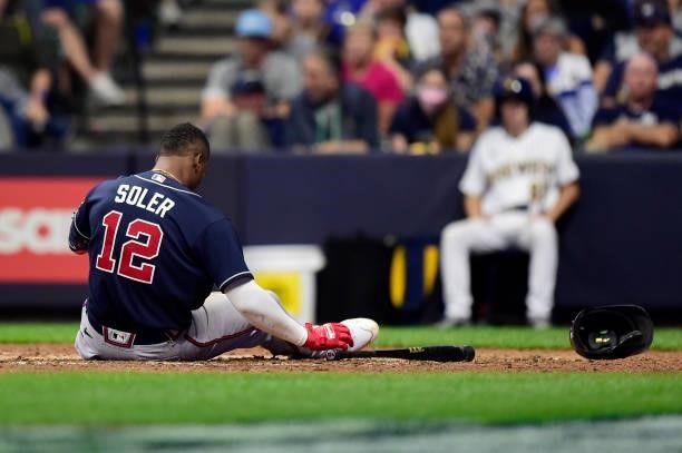 Jorge Soler of the Atlanta Braves falls to ground after avoid a pitch in the ninth during game 2 of the National League Division Series against the...