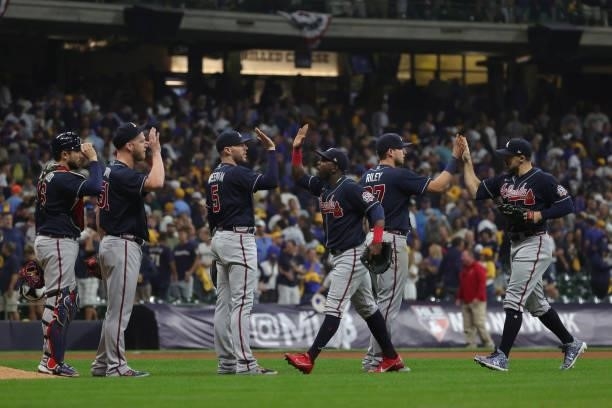 The Atlanta Braves celebrate a win over the Milwaukee Brewers during game 2 of the National League Division Series at American Family Field on...