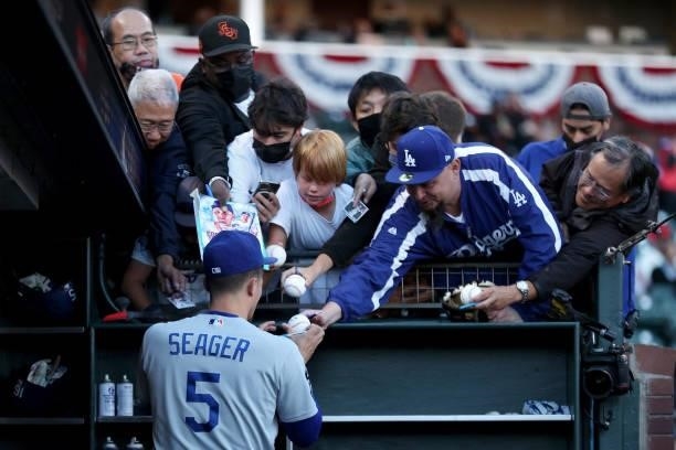 Corey Seager of the Los Angeles Dodgers signs autographs for fans before Game 2 of the National League Division against the San Francisco Giants...