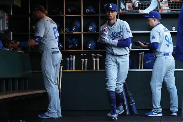 Justin Turner and Mookie Betts of the Los Angeles Dodgers walk through the dugout before Game 2 of the National League Division Series against the...