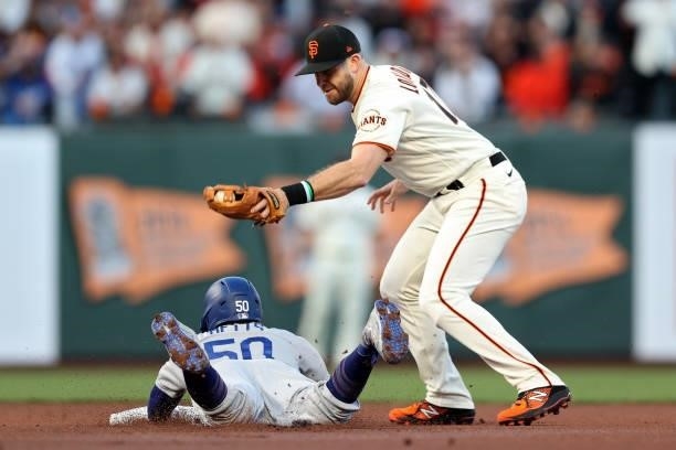 Mookie Betts of the Los Angeles Dodgers steals second base past Evan Longoria of the San Francisco Giants in the first inning during Game 2 of the...