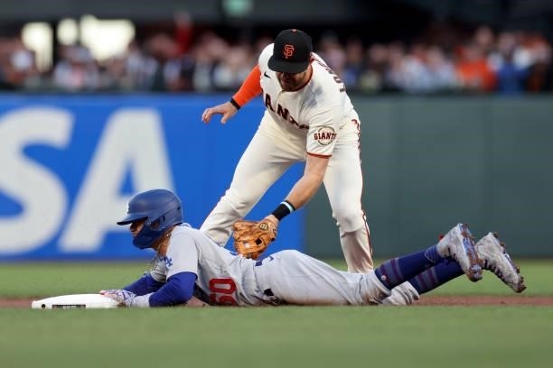 Mookie Betts of the Los Angeles Dodgers steals second base past Evan Longoria of the San Francisco Giants in the first inning during Game 2 of the...