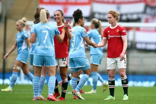 Players shake hands at full time during the Barclays FA Women's Super League match between Manchester United Women and Manchester City Women at Leigh...