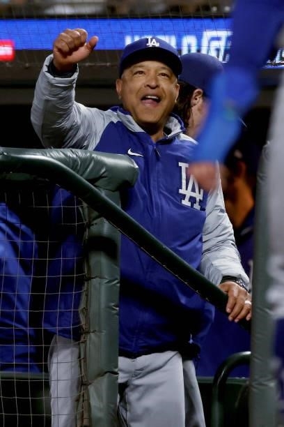 Manager Dave Roberts of the Los Angeles Dodgers celebrates after Cody Bellinger and Chris Taylor scored runs in the sixth inning against the San...