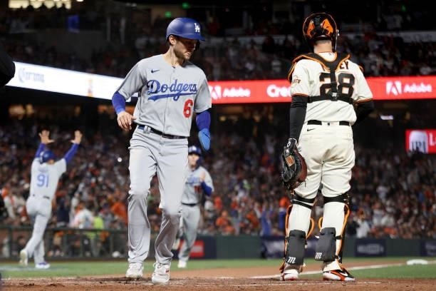 Trea Turner of the Los Angeles Dodgers scores a run past Buster Posey of the San Francisco Giants in the sixth inning during Game 2 of the National...
